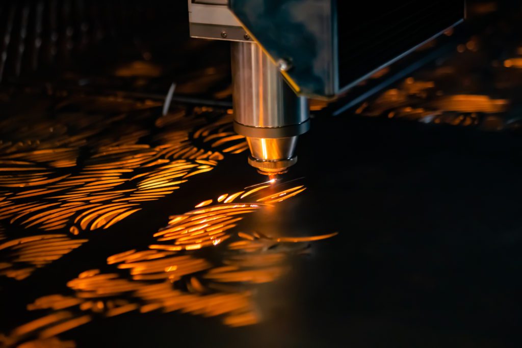 Automatic cnc laser cutting machine working with sheet metal with sparks Automatic cnc laser cutting machine working with sheet metal with sparks